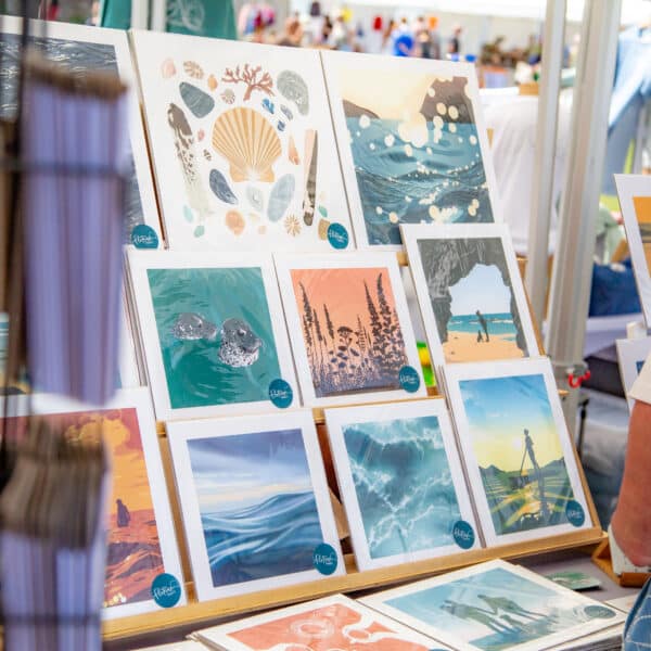 A sunny market stall displaying sea inspired art prints