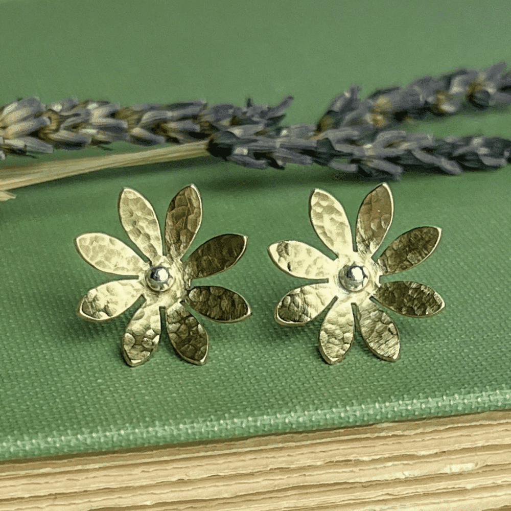 Pair of gold flower shaped stud earrings
