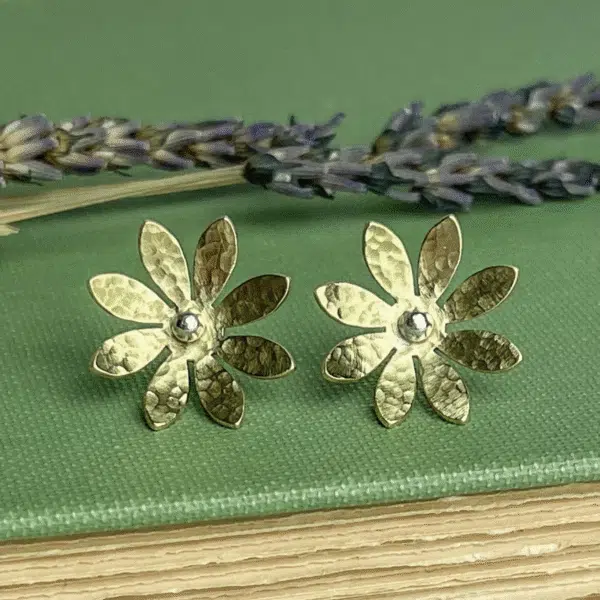 Pair of gold flower shaped stud earrings