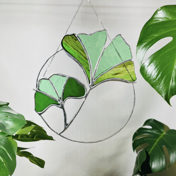 Glass hanging decoration with green leaves