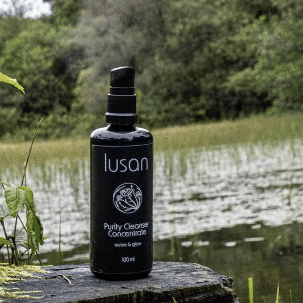 A black coloured bottle containing skincare