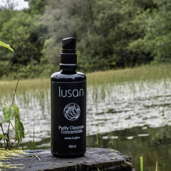 A black coloured bottle containing skincare