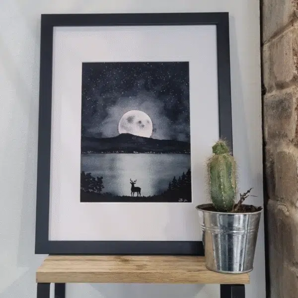 Beautiful watercolour painting of a stag looking at the moon's reflection on a loch
