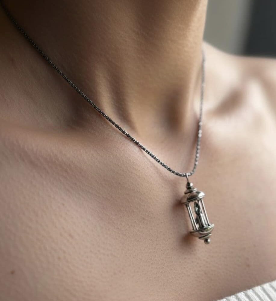 A little lantern pendant made from silver. A candle burns in the centre and a little drip of wax moves down the candle. The light symbolises what is ‘Always Within’ us, even if we lose sight of it sometimes…