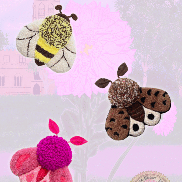Close-up of handmade punch needle moths, and a bee on a pastel spring background with pink flowers, trees, and a church illustration.
