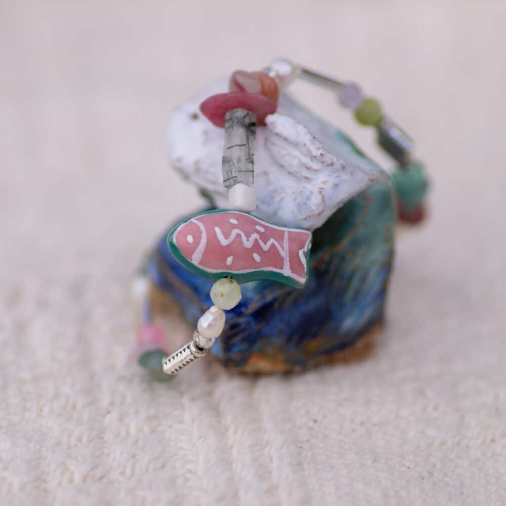 Pink & green ceramic fish on a beaded gemstone bracelet with sterling silver clasp.