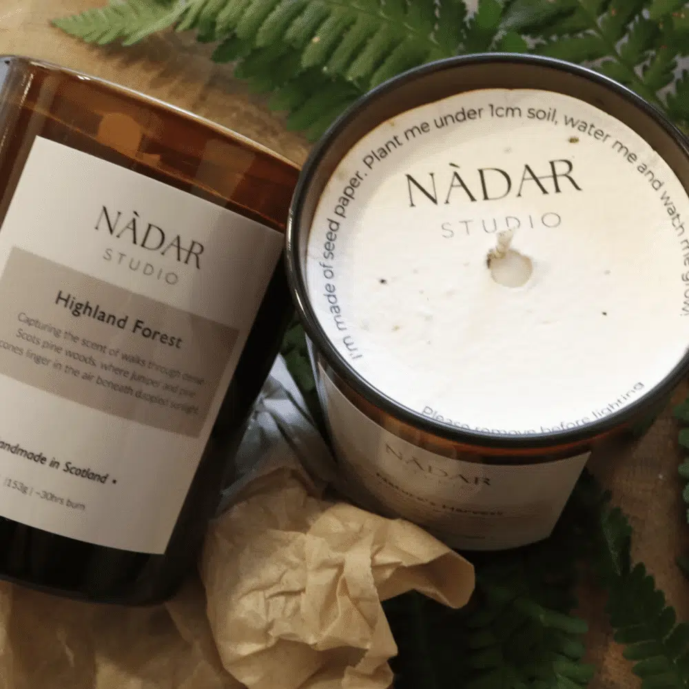 Two scented candles in brown glass jars