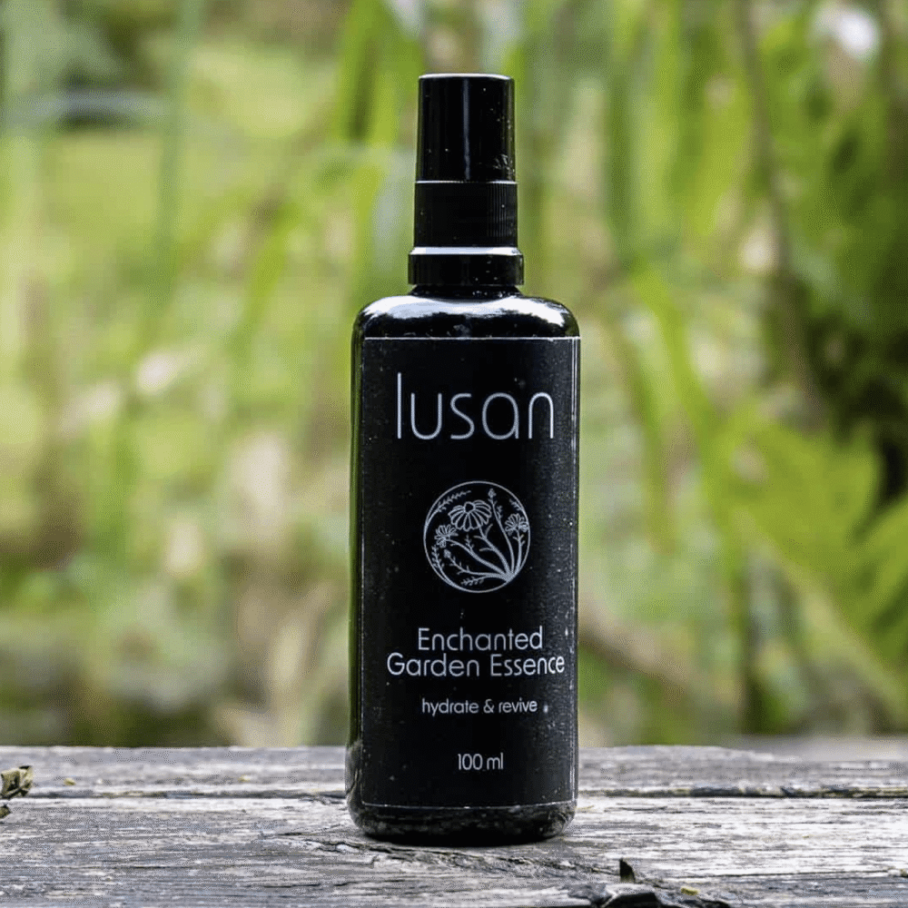 Black bottle with garden background containing organic skincare