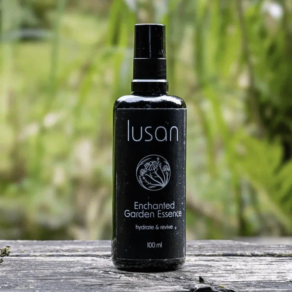 Black bottle with garden background containing organic skincare