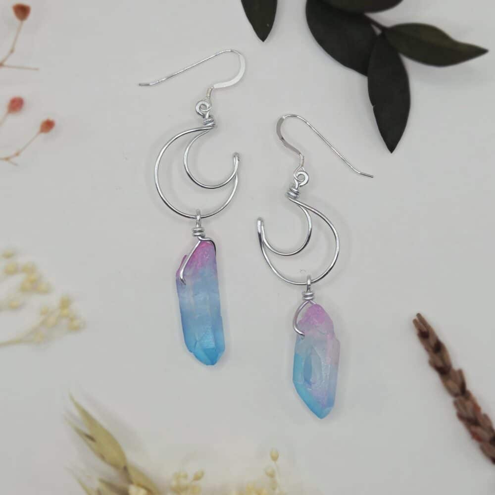 A pair of silver earrings in crescent moon shape, with blue and pink quartz points by SunstoneAndFern