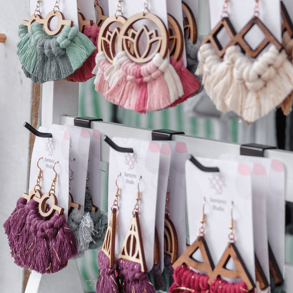 Handmade macramé earrings in colourful designs with wooden geometric shapes. Sambrini Studio